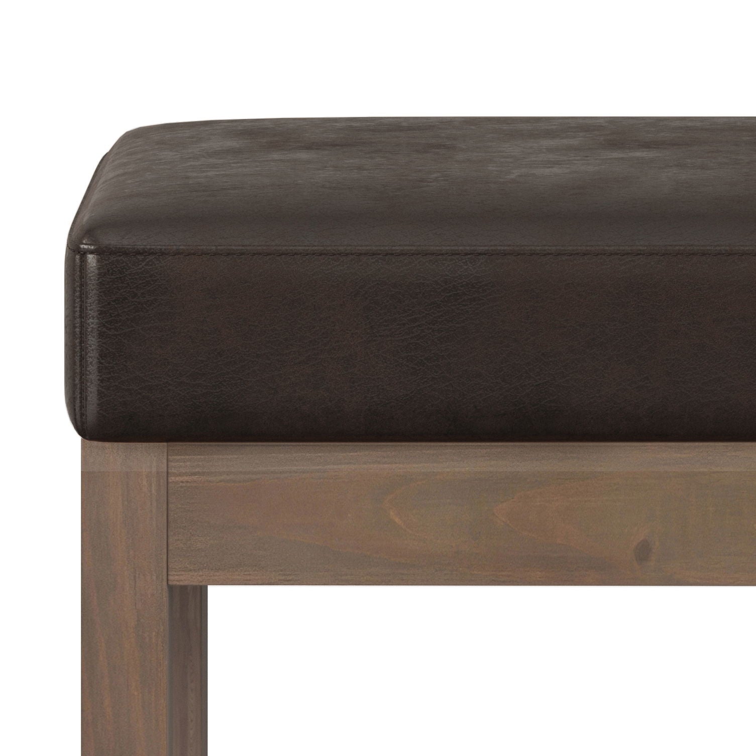 Close-up of the Milltown - Upholstered Ottoman Bench featuring a thick, dark brown leather cushion on a light wood frame, set against a white background.