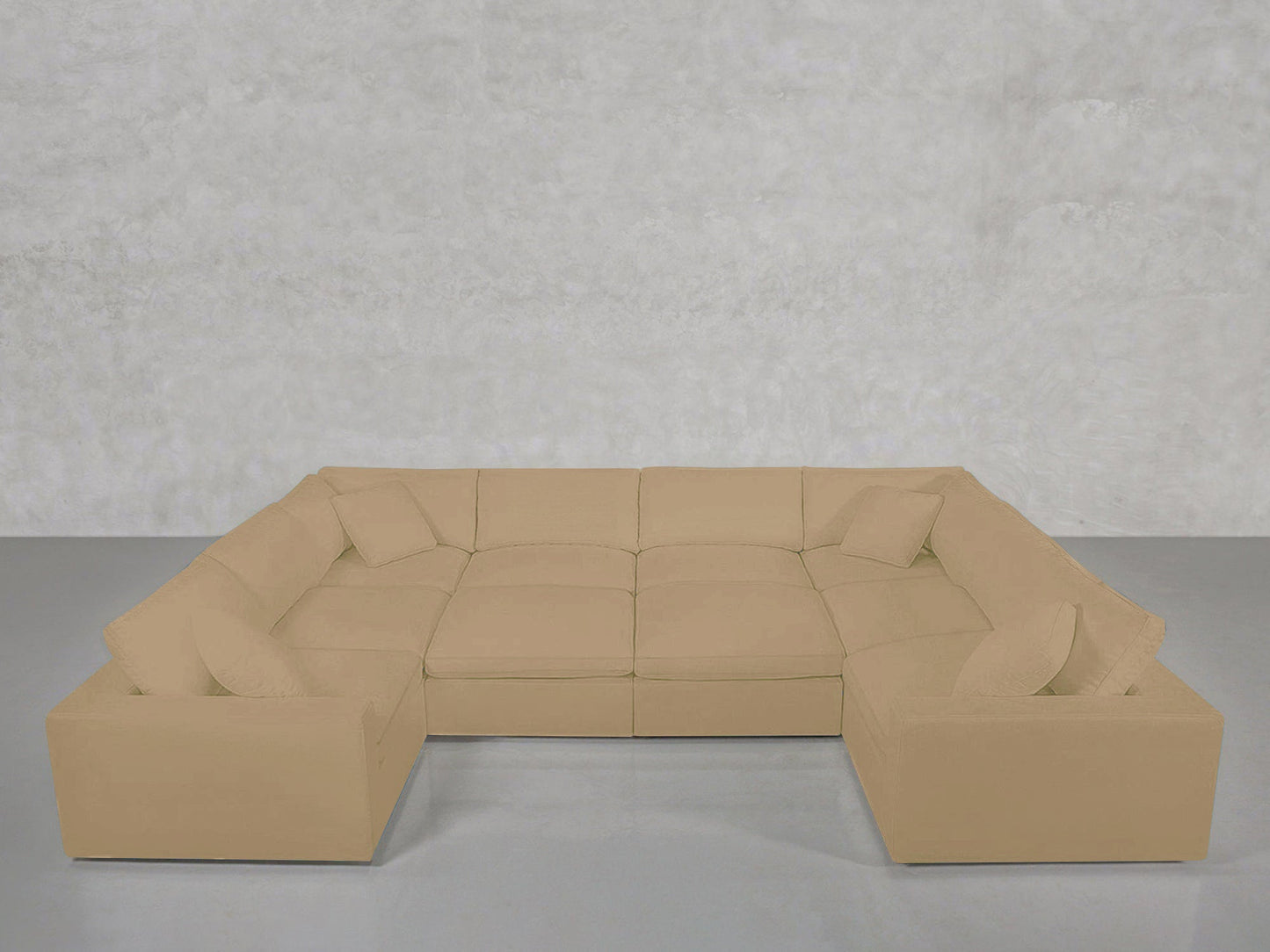 A spacious beige 10-Seat Modular Closed Pit sectional with matching cushions is arranged on a gray floor against a plain, light gray textured wall.