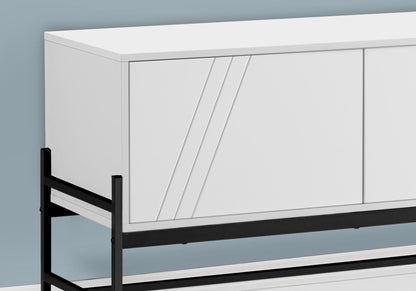 A contemporary white TV stand and storage cabinet with sleek diagonal accents on the doors, featuring a black metal frame, placed against a light blue wall.