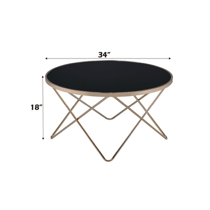 The Valora - Glass Coffee Table features a black glass top with a gold metal frame, measuring 34" in diameter and 18" high. Arrows and text show the table's dimensions.