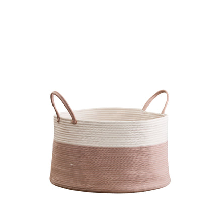 The Francis - Cotton Round Laundry and Storage Basket has two handles, an off-white top half, and a light pink bottom half. It’s woven and round, shown against a plain white background.