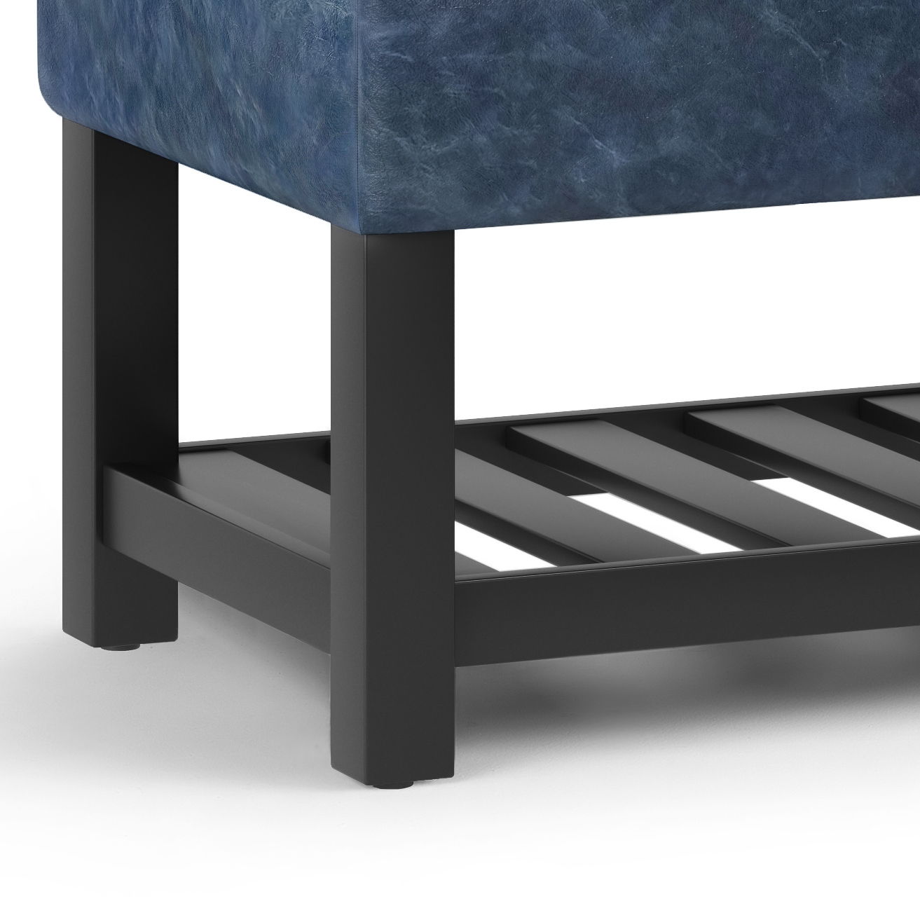 Close-up of the Cosmopolitan Storage Ottoman Bench with blue upholstery, black metal legs, and a black slatted open bottom shelf, shown on a white surface.