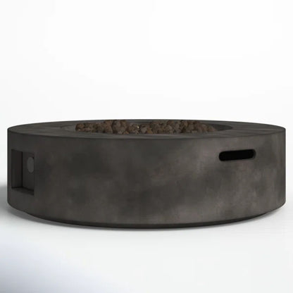 The Fiber Reinforced Outdoor Fire Pit Table in Black/Gray features a round, modern design with a recessed stone-filled center, side handle slot, and left-side control panel, shown against a plain white background.
