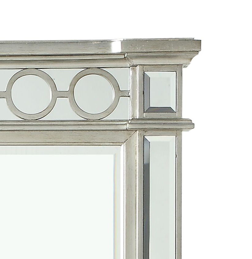 A close-up of the Varian - Mirrored Designed Mirror - Silver shows its metallic frame with geometric circle and rectangle accents in a sleek silver finish.