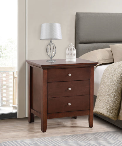 The Hammond - 3 Drawer Nightstand with silver knobs stands by the bed. On top sit a modern silver lamp with a white shade and a small white decor piece, complementing the room’s neutral tones and cozy feel.