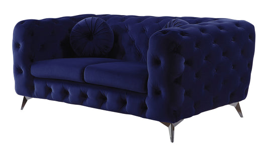 The Atronia Velvet Loveseat features plush dark blue velvet, tufted upholstery, rounded arms, angled metal legs, and comes with two matching round cushions.