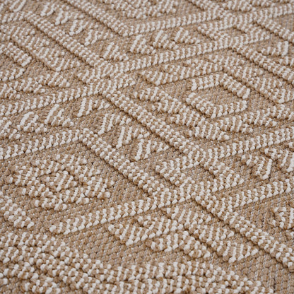A close-up of the Guros - Traditional Indoor / Outdoor Area Rug, featuring a raised white geometric pattern on a beige background, showcases its textured, visually intricate design.