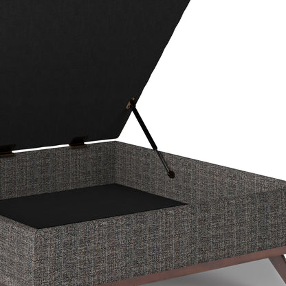 A close-up of the Owen Multifunctional Square Coffee Table Storage Ottoman, featuring a textured gray fabric exterior, black interior, and a hinged lid supported by a metal rod.