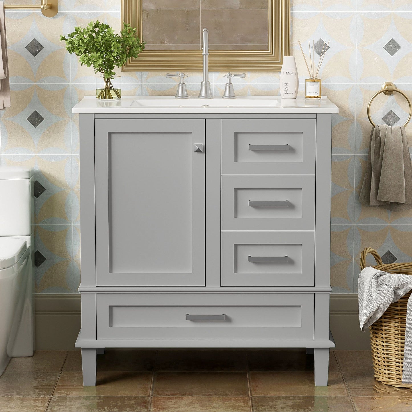 A modern bathroom vanity with sink combo features a solid wood frame, white countertop, soft closing door, and three drawers. A towel ring and basket of towels are nearby, with a framed mirror above the cabinet.