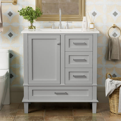 A modern bathroom vanity with sink combo features a solid wood frame, white countertop, soft closing door, and three drawers. A towel ring and basket of towels are nearby, with a framed mirror above the cabinet.