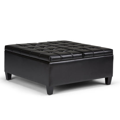 The Harrison Large Coffee Table Storage Ottoman features a black, square leather design with a tufted top and short legs, shown on a white background.