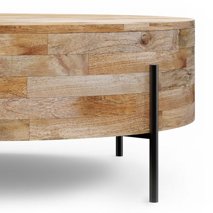 A close-up of the Rayburn Drum Coffee Table in Natural, showcasing its round shape, light wood finish with panel design, and slender black metal legs against a white background.