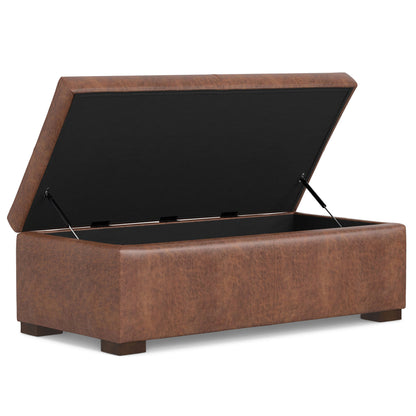 The Gabbie Coffee Table Upholstered Storage Ottoman features a rectangular brown faux leather design, a hinged lid revealing ample storage, short wooden legs, and a sleek modern style.