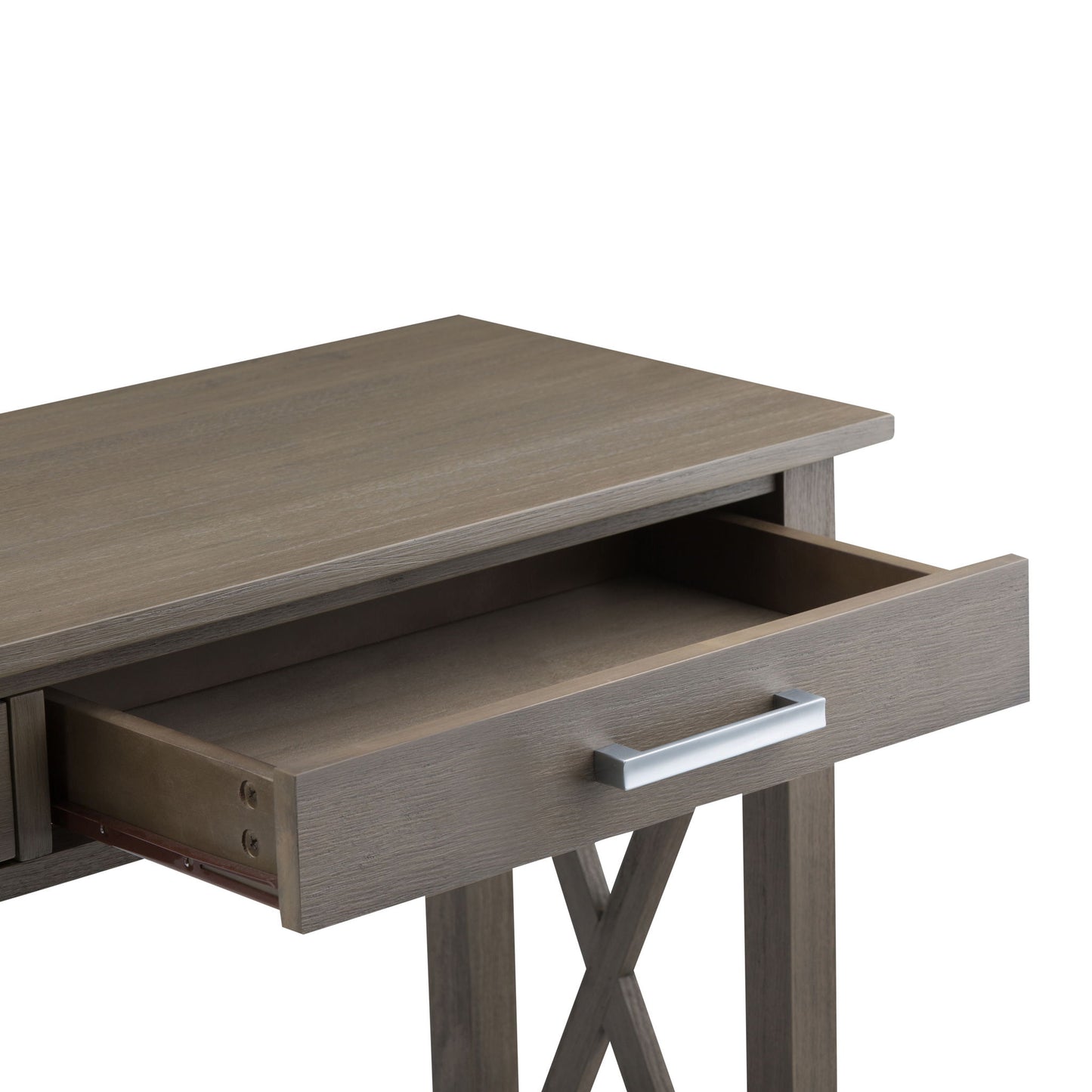 The Kitchener - Handcrafted Table features a rectangular wooden top and X-shaped side supports. It is shown with one open drawer, revealing an empty interior and a sleek silver handle.