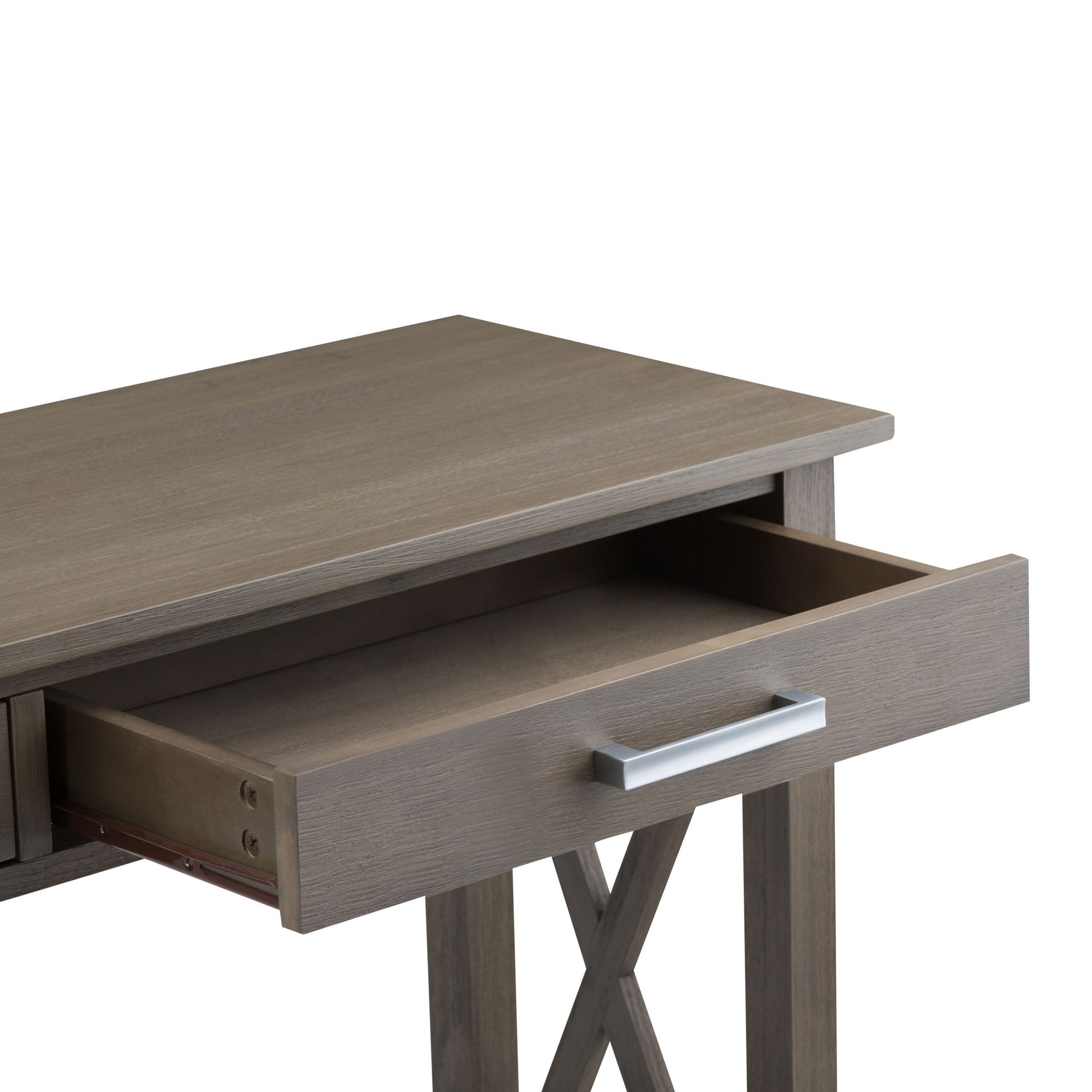 The Kitchener - Handcrafted Table features a rectangular wooden top and X-shaped side supports. It is shown with one open drawer, revealing an empty interior and a sleek silver handle.