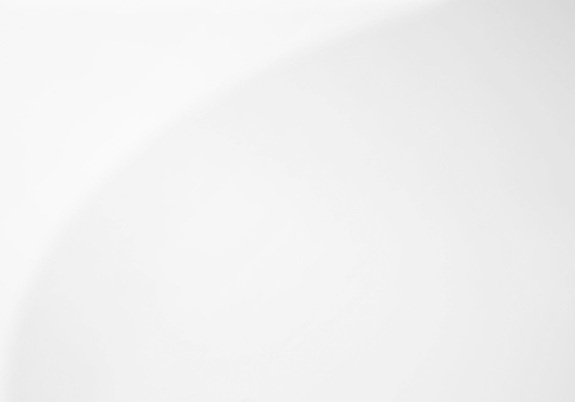 A minimalistic image featuring the Coffee Table Rectangular For Living Room Clear Tempered Glass on a smooth white background with a faint, curved shadow or gradient in the upper right corner.