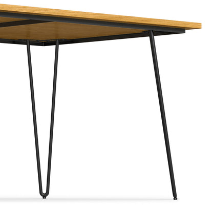 A close-up view of the Hunter - Square Tabletop Dining Table, featuring a light wood square top and black metal hairpin legs, set against a white background.