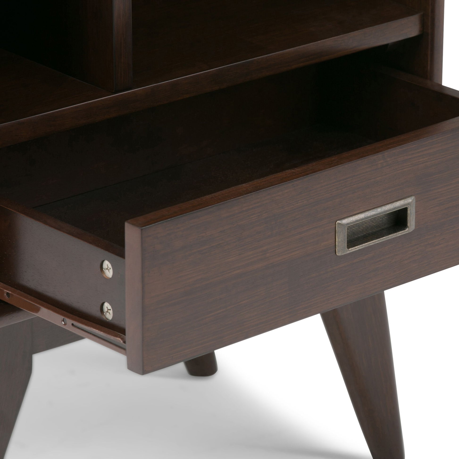 A close-up of the Draper Mid Century Wide Bookcase and Storage Unit shows its dark wood finish, open drawer, angled legs, and a rectangular metal handle on the drawer front.