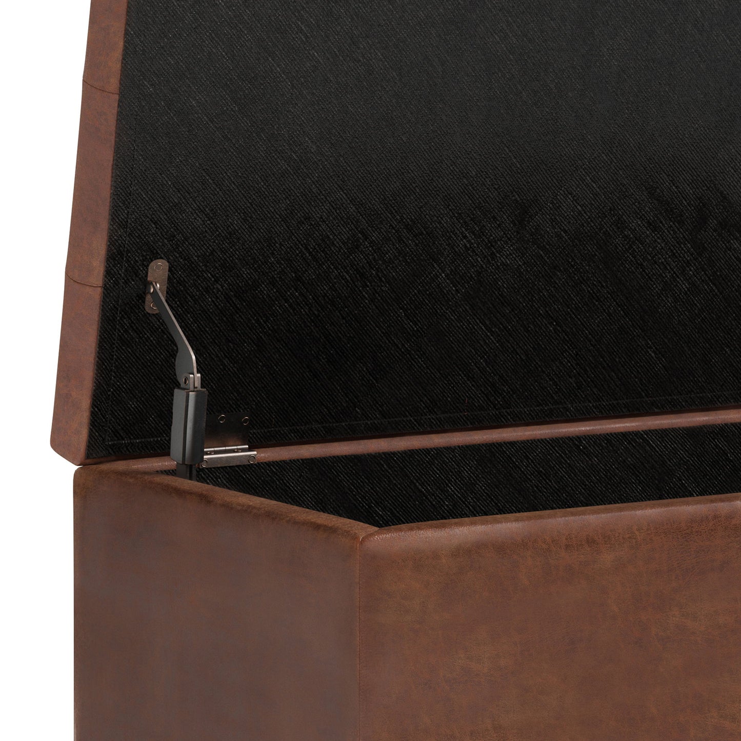 A close-up of the Cosmopolitan Upholstered Storage Ottoman with its hinged brown leather lid open, revealing a black fabric-lined interior.