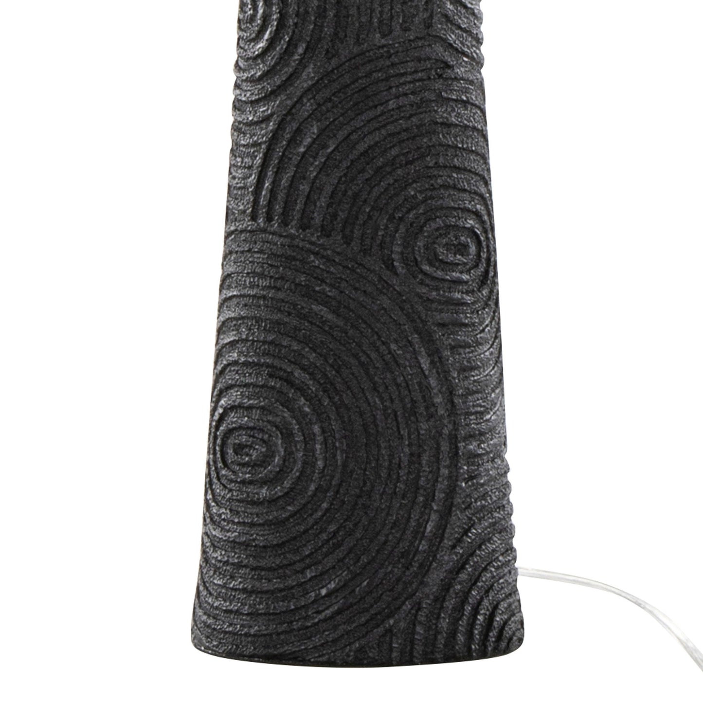 Close-up of the Kona - Contemporary Table Lamp (Set of 2) in Matte Black, showing its textured base with concentric circles and a white power cord extending from the right.