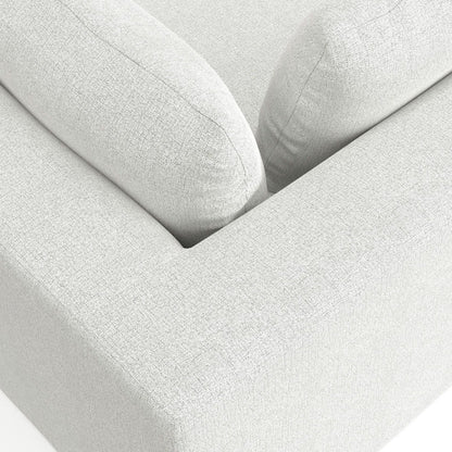 Close-up of the Jasmine - Handcrafted Sofa in light gray textured fabric, featuring two large back cushions and part of the armrest, showcasing its clean lines and minimalistic design.