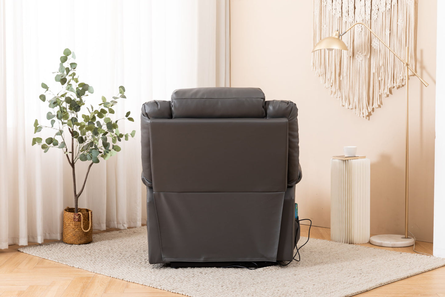 An Electric Power Massage Recliner Chair in dark gray is positioned in a cozy, light room with a potted plant, floor lamp, side table, and wall art visible in the background.