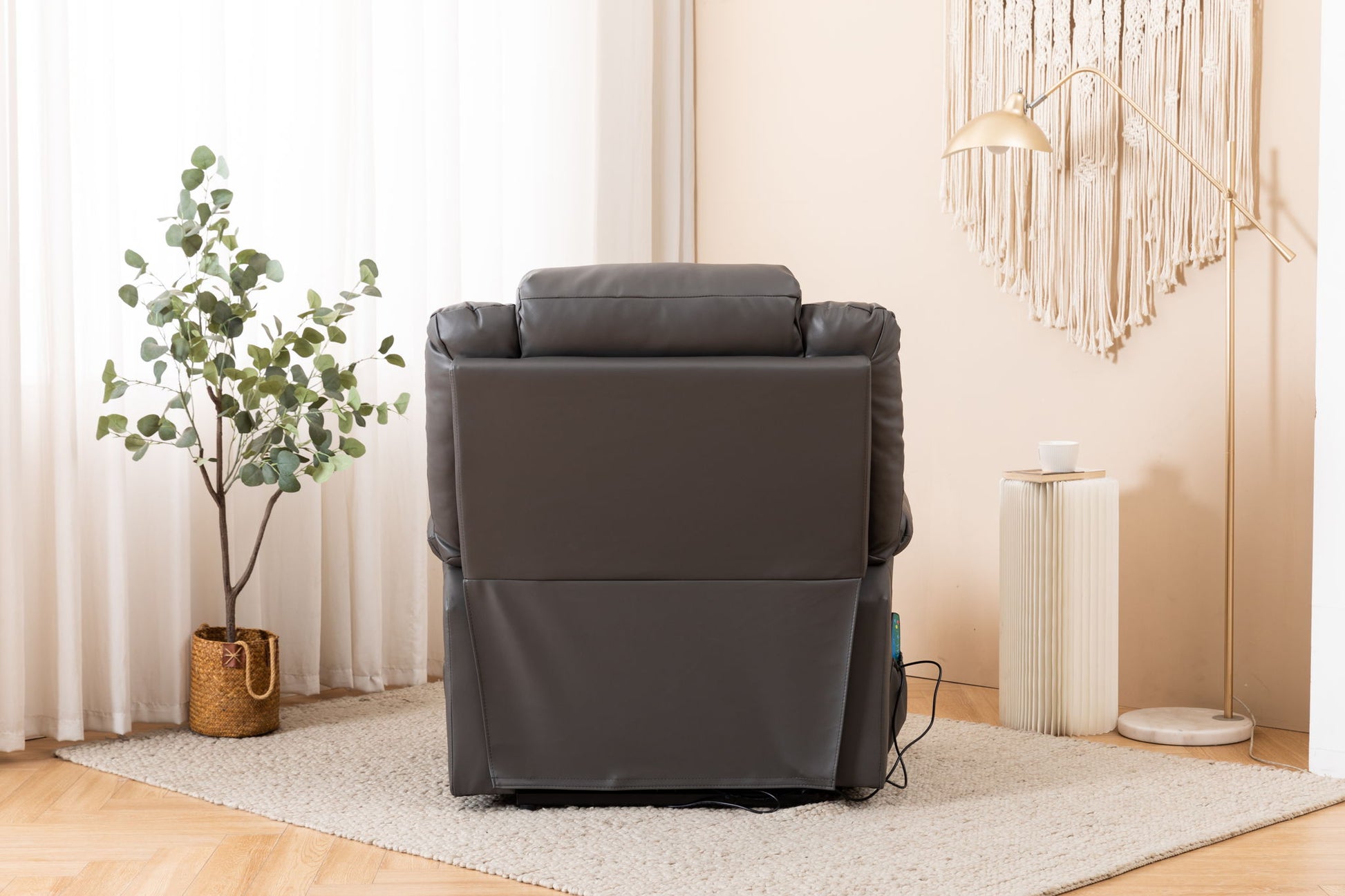An Electric Power Massage Recliner Chair in dark gray is positioned in a cozy, light room with a potted plant, floor lamp, side table, and wall art visible in the background.