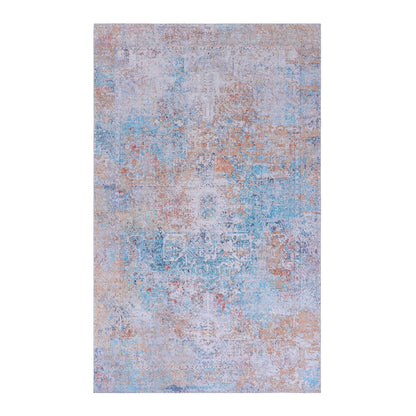 The Maval - Unique Washable Area Rug showcases a distressed, vintage-inspired pattern in faded pastel blue, peach, and cream with subtle intricate details throughout.