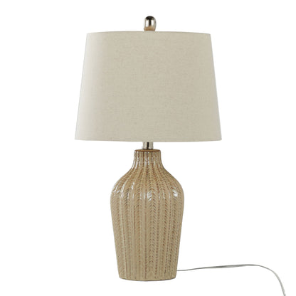 The Rockwell - Contemporary Table Lamp (Set of 2) features a beige textured ceramic base with a leaf-like pattern, a plain light fabric shade, and a white power cord extending from the base.