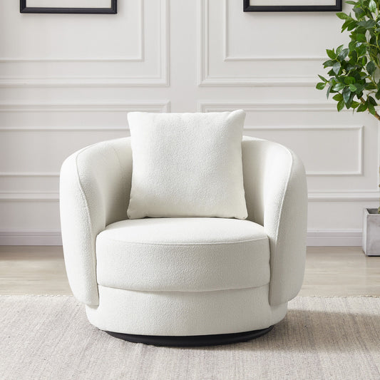 The Dylan Boucle Lounge Chair in modern white, featuring a matching square pillow, sits on a light rug beside a potted plant in a room with white paneled walls.