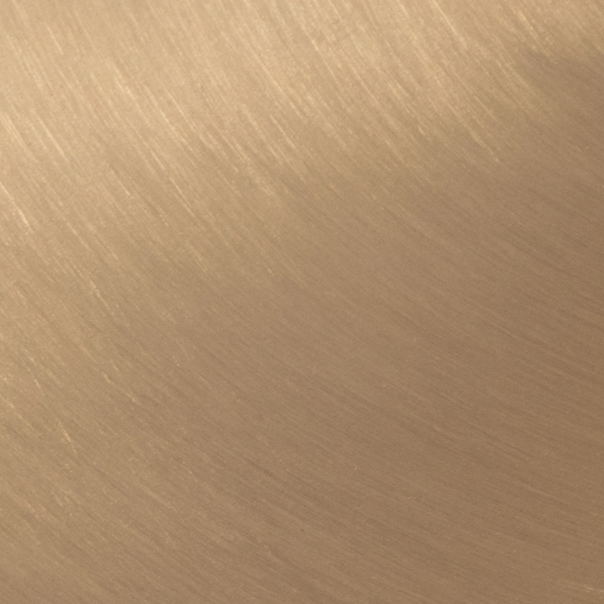 Close-up of Bora - Contemporary Table's smooth, brushed metal surface in a warm golden-brown tone. Fine linear textures add an elegant pattern and modern appeal.
