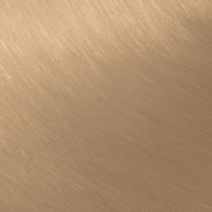 Close-up of Bora - Contemporary Table's smooth, brushed metal surface in a warm golden-brown tone. Fine linear textures add an elegant pattern and modern appeal.