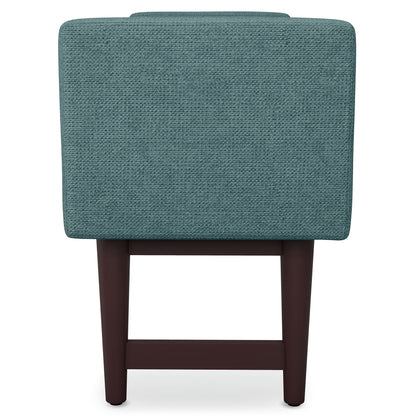 Back view of the Scott - Upholstered Ottoman Bench featuring teal fabric and dark wooden legs against a plain white background.