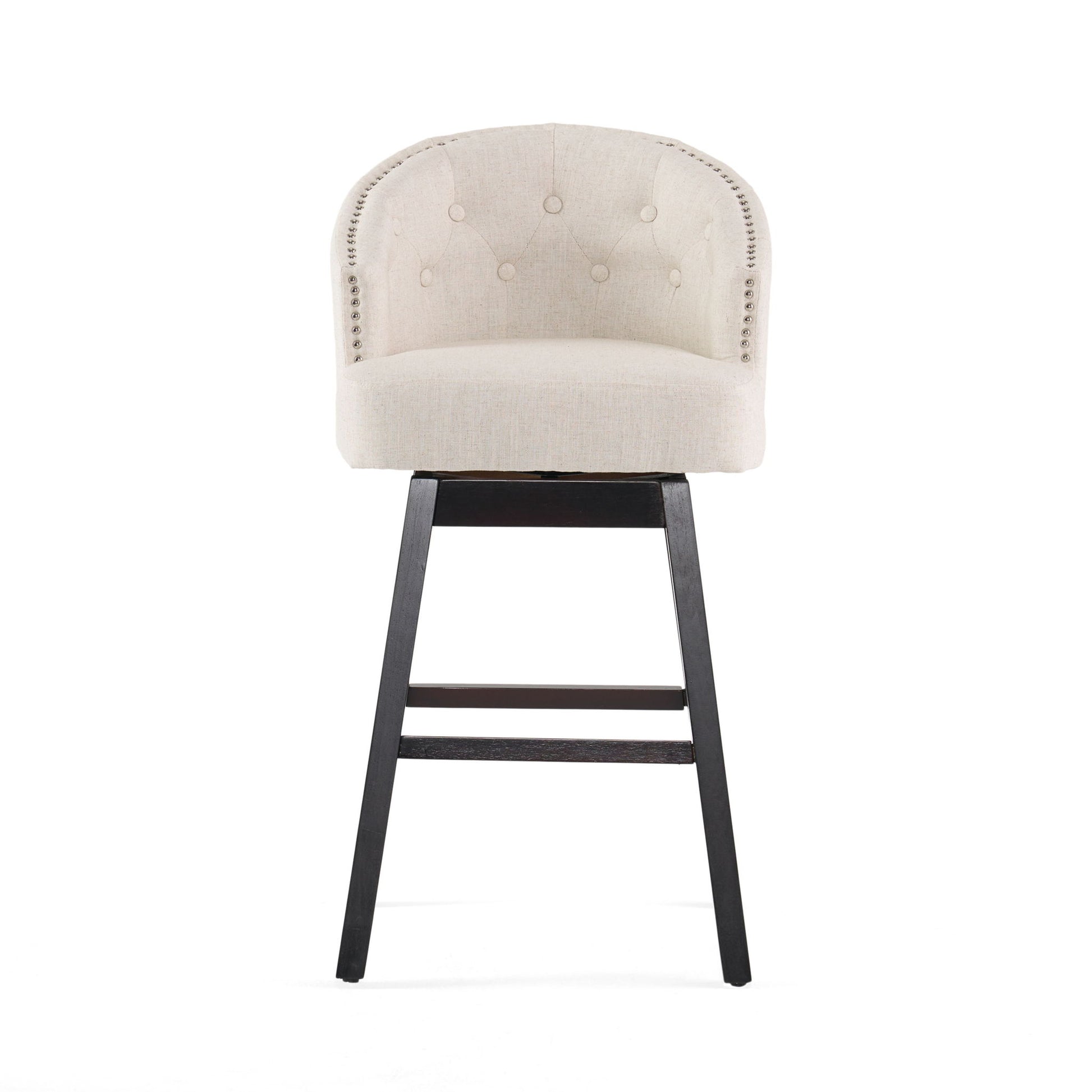 The Mellifluous 360 Degree Swivel Bar Stool, set of 2, features a beige upholstered seat, rounded tufted backrest, striking silver nailhead trim, and black wooden legs—perfectly stylish against a white background.