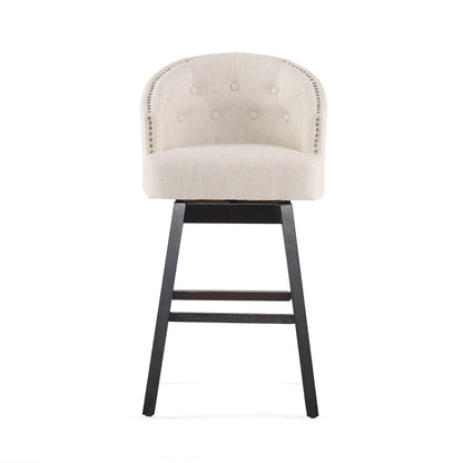 The Mellifluous 360 Degree Swivel Bar Stool, set of 2, features a beige upholstered seat, rounded tufted backrest, striking silver nailhead trim, and black wooden legs—perfectly stylish against a white background.