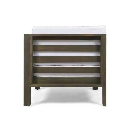 The Oana Arm Chair features wide, horizontal wooden slats on the backrest and a white upholstered cushion, shown from the back against a white background.