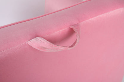 Close-up of a soft, light pink fabric handle sewn onto the Durable Design Kids Club Sofa, featuring a matching pink color, smooth texture, and gentle lighting.
