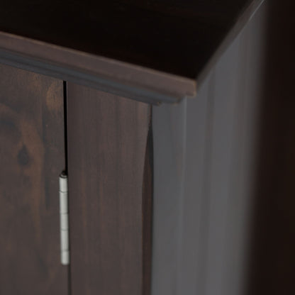Close-up of the Acadian - Medium Storage Cabinet, Handcrafted, focusing on its dark wood edge, side panel, door with a visible silver hinge, and highlighting the rich wood grain and smooth finish.