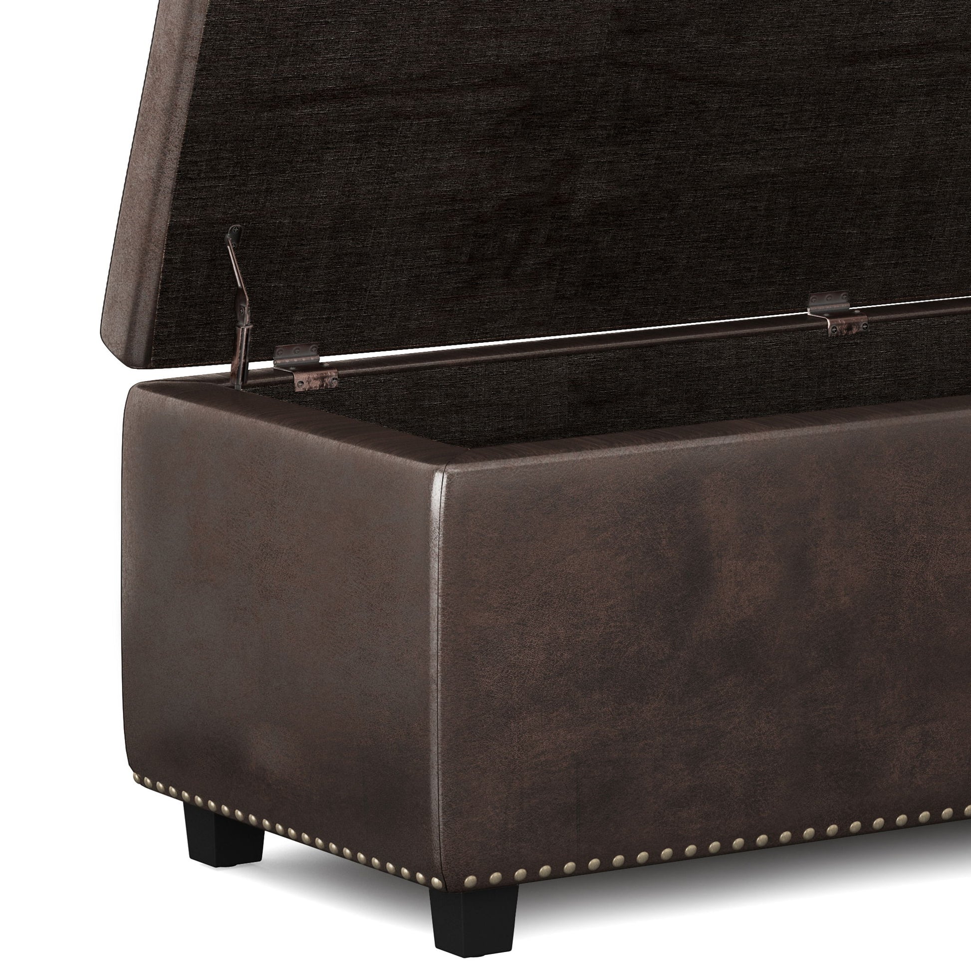 The Hamilton Upholstered Storage Ottoman is shown with its lid open, revealing the interior. It features dark brown upholstery, short black legs, metal hinges, and decorative nailhead trim along the bottom edge.