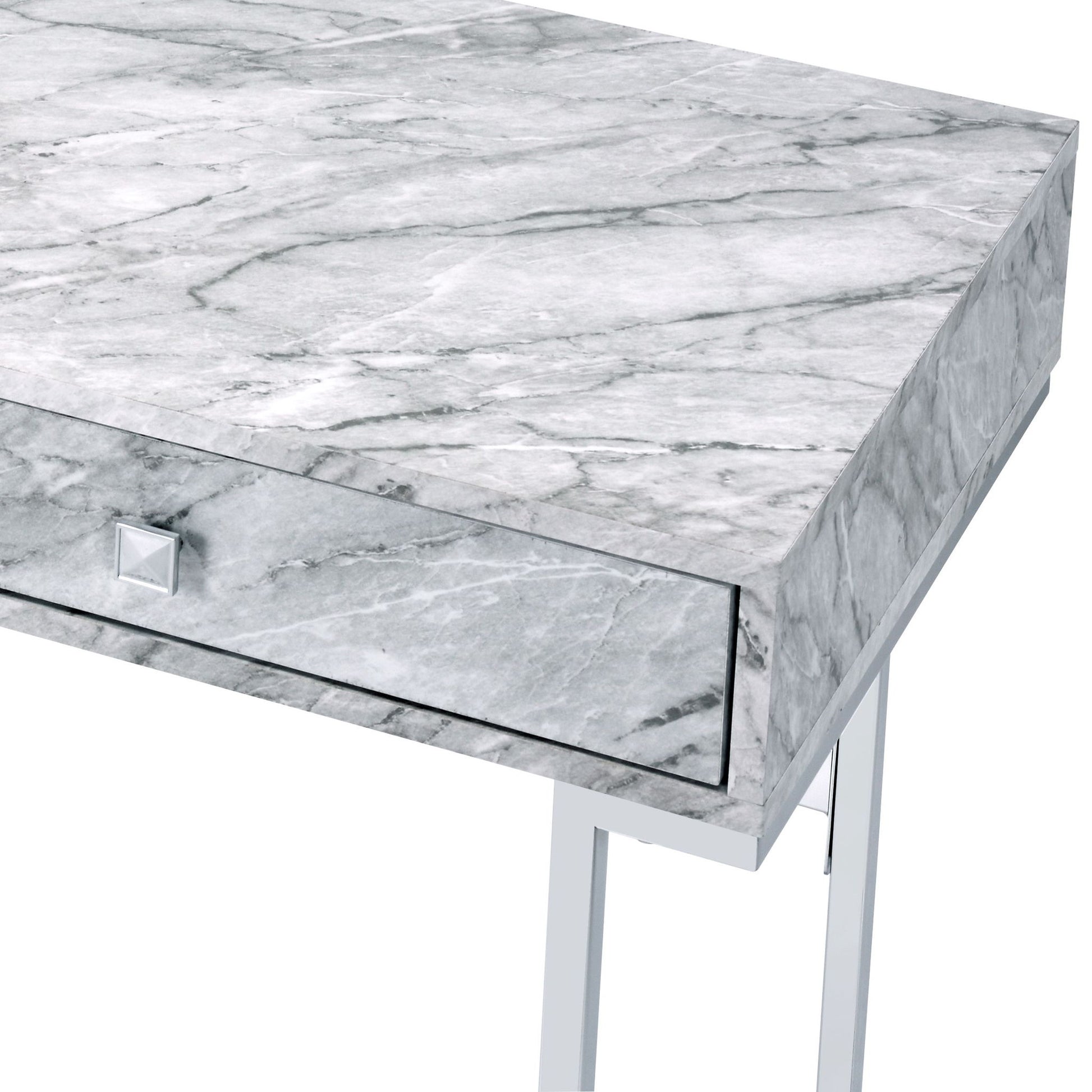 A close-up of the Tigress Printed Faux Marble Top Writing Desk in white, featuring a gray marble-patterned surface, a single front drawer with a square silver knob, and sleek metal legs.