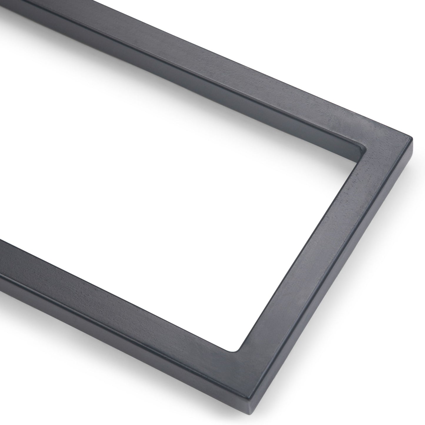 A close-up of the Skyler - C Side Handcrafted Table’s rectangular, dark gray frame against a white background, highlighting the corner and sides.