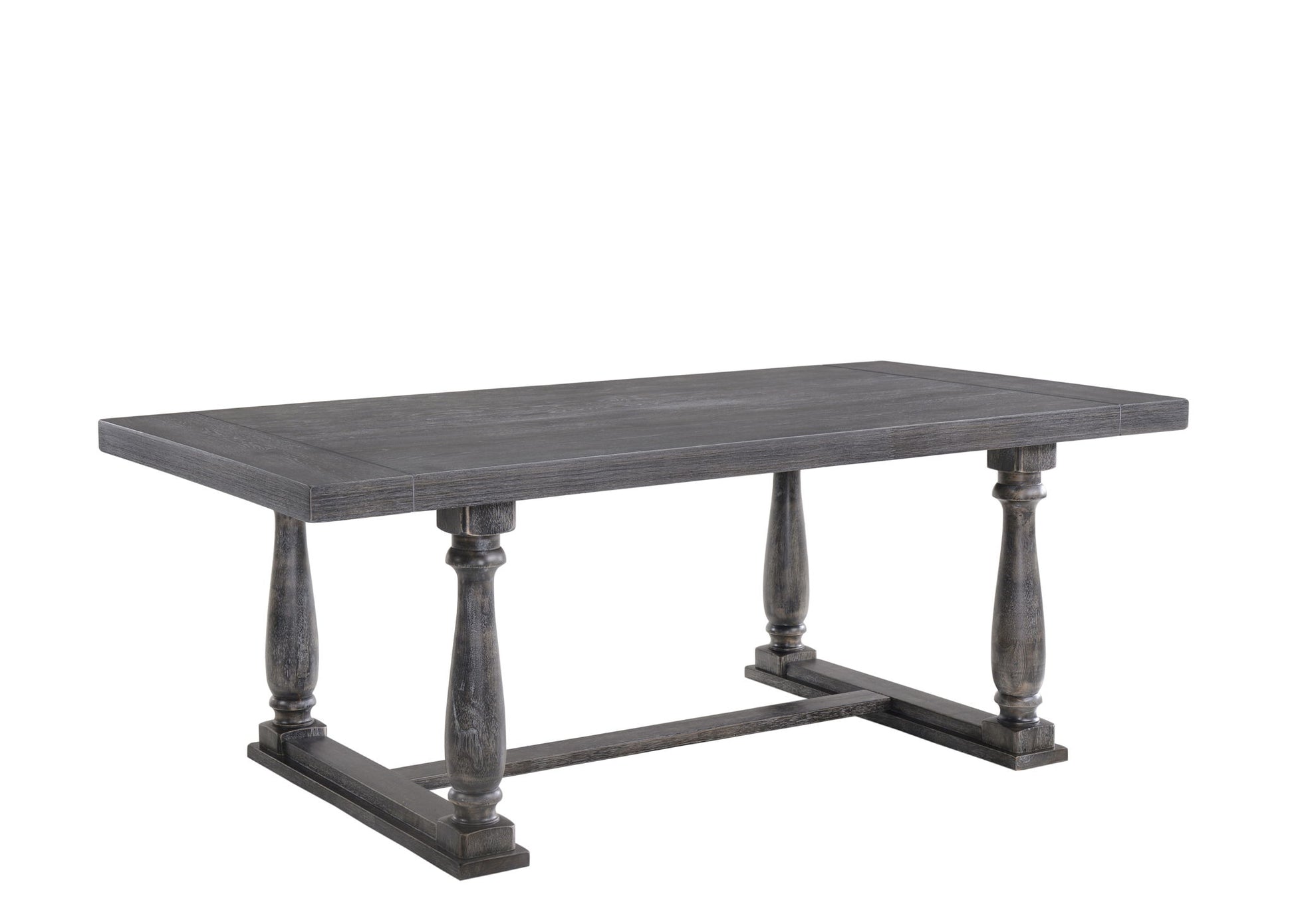 The Bernard - Weathered Dining Table is a rectangular wooden dining table with a dark finish and four turned legs joined by a horizontal support at the base.