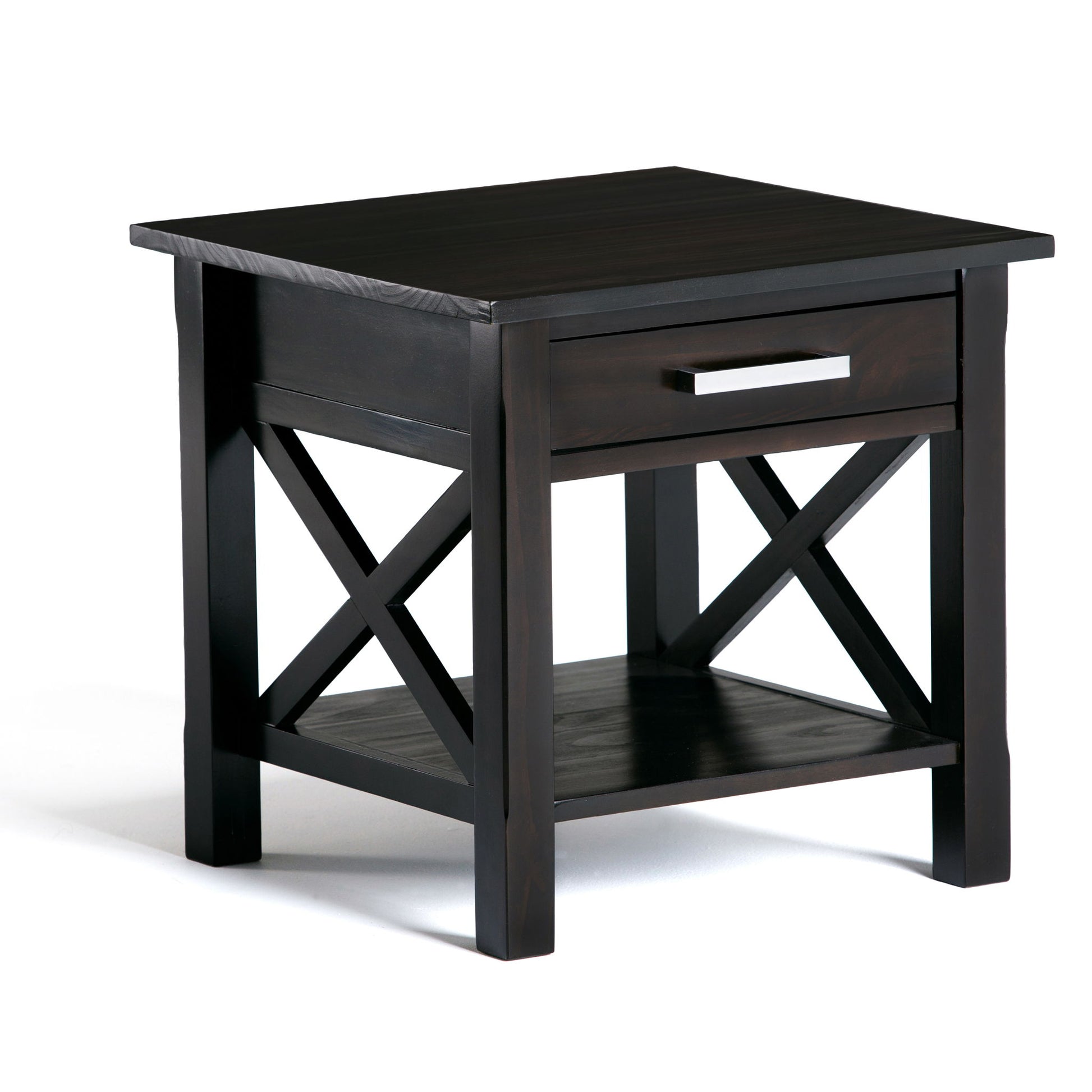 The Kitchener - Handcrafted Table is a dark wood end table featuring a single drawer with a silver handle, a lower shelf, and X-shaped side supports, shown against a white background.