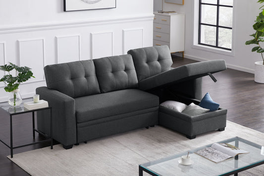 The Upholstered Pull Out Sectional Sofa With Chaise in dark gray features tufted cushions and a storage chaise with included pillows, set in a bright living room with white walls, large windows, and modern decor.