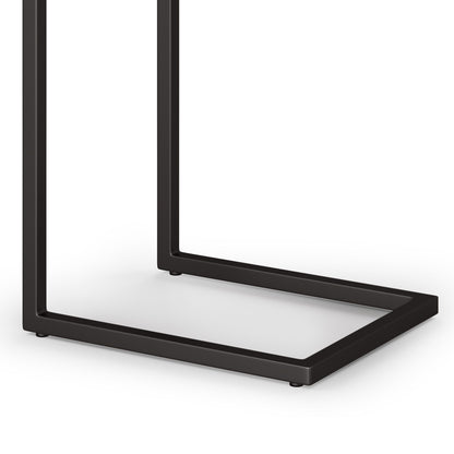The Skyler - Handcrafted C Side Table features a minimalist black metal base with a geometric, open rectangular design. Its modern, sleek look is defined by clean lines and a simple structure, perfect for contemporary spaces.