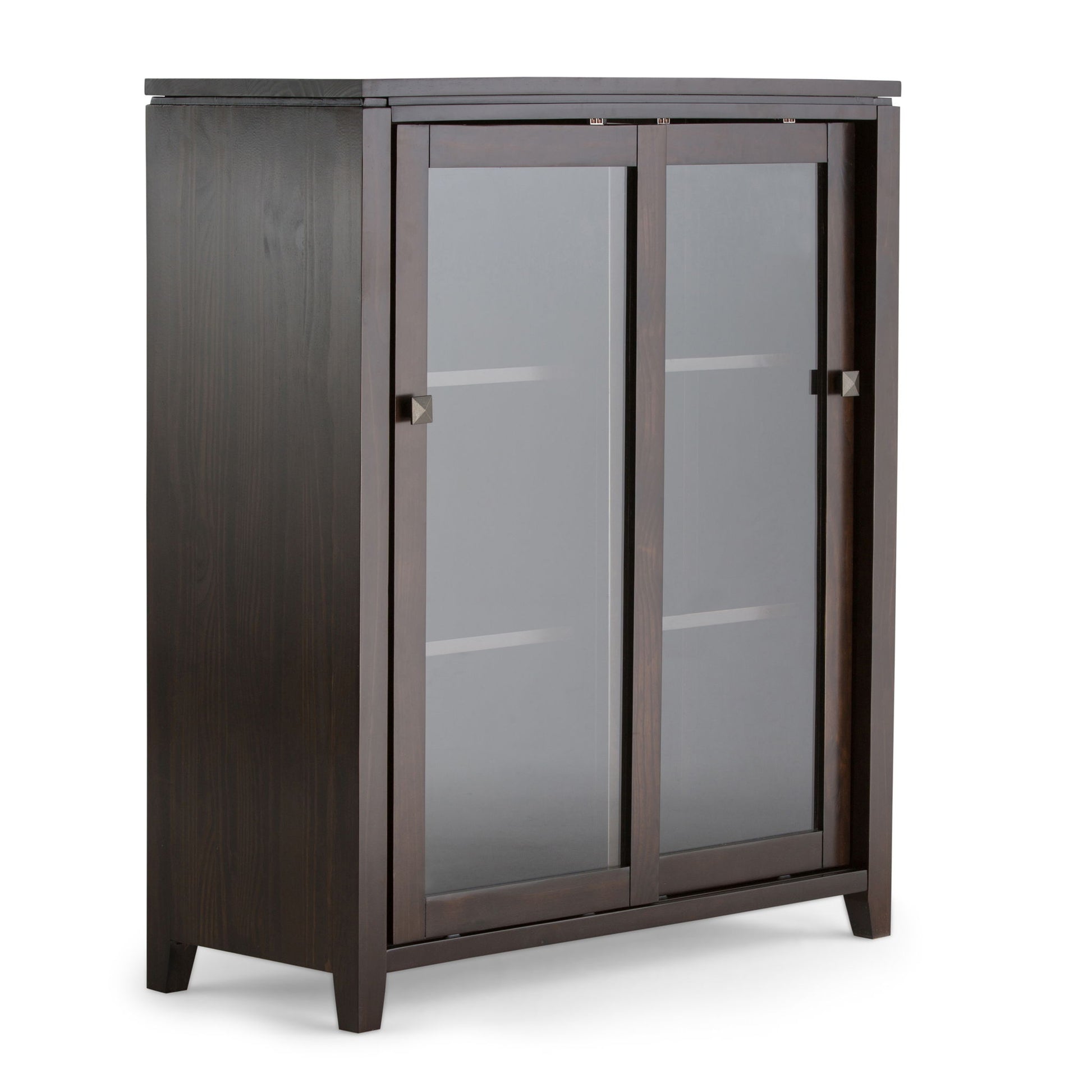 Cosmopolitan - Handcrafted Medium Storage Cabinet features dark wood, two frosted glass sliding doors with square metal handles, two interior shelves, and four short legs. Displayed against a plain white background.