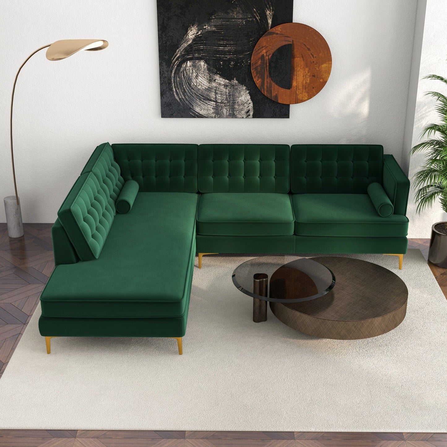 A modern living room featuring the Christian Mid-Century Modern Design Sectional Sofa in green, a round glass and wood coffee table, tall floor lamp, abstract wall art, and a potted plant on a white rug over patterned wood flooring.