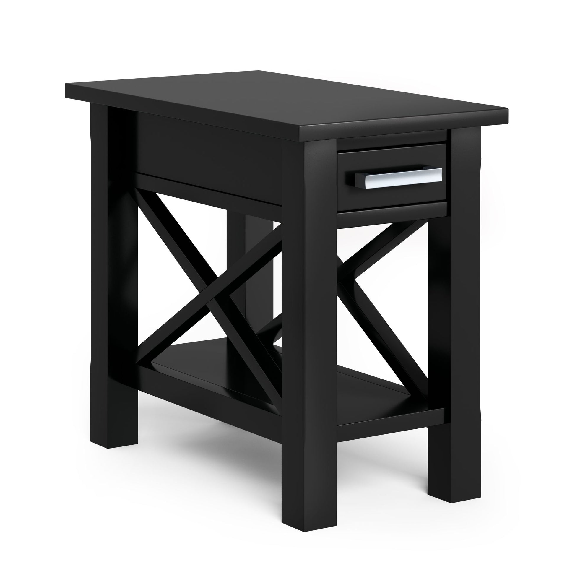 The Kitchener Handcrafted Table is a black wooden side table featuring a single drawer with a silver handle, crossed side supports, and a lower shelf, shown against a plain white background.
