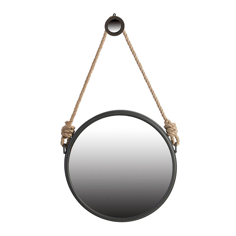 The Handsome Cleveland Mirror features a round metal frame in black and hangs from a thick knotted rope looped over a black hook, blending contemporary design with stylish wall decor.