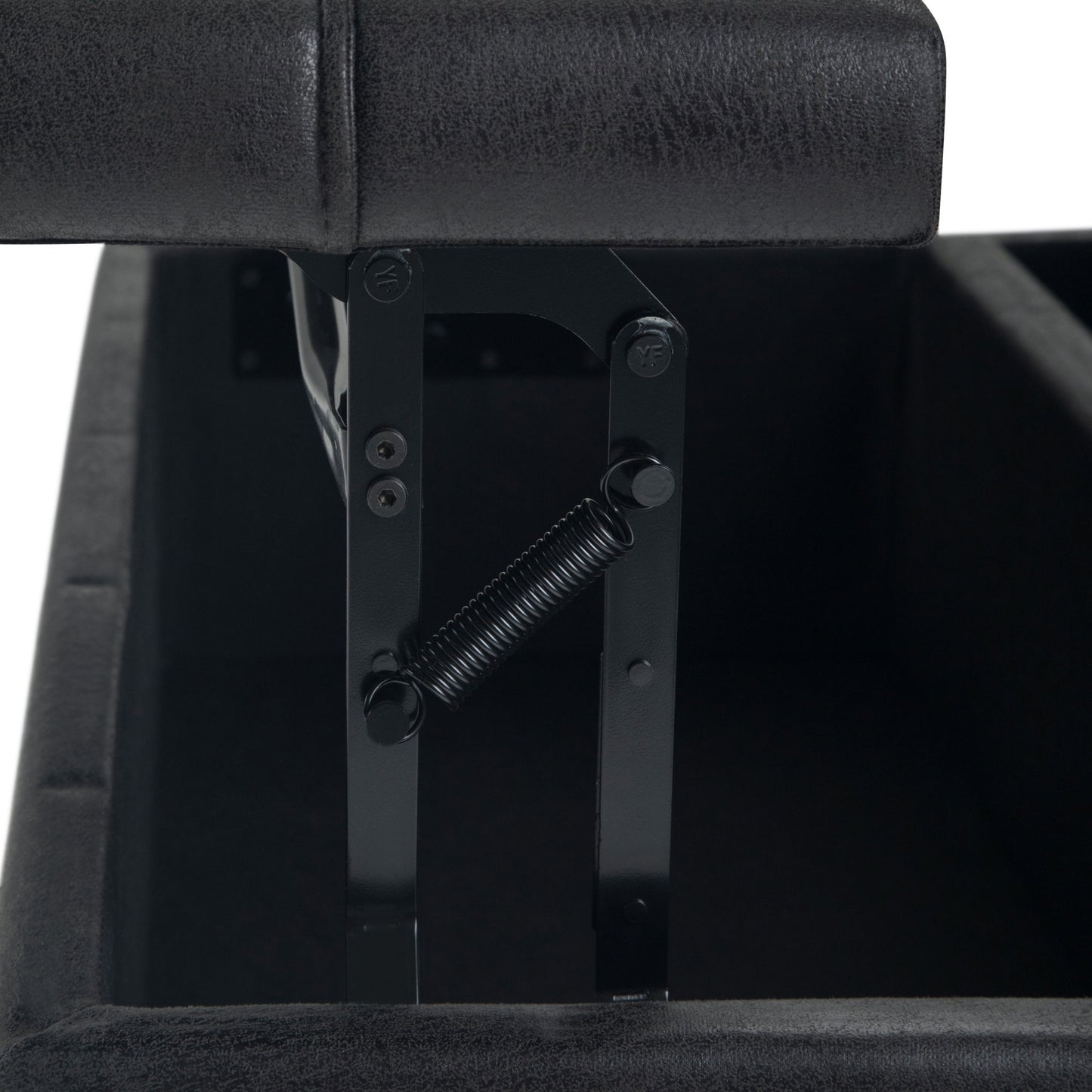 Close-up of the Harrison - Upholstered Coffee Table Storage Ottoman in black, with the lid partially open to reveal the metal hinge and spring mechanism. Both interior and exterior are upholstered in matching black material.